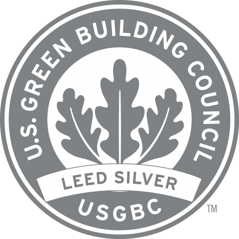 Round silver logo with 3 leaves with the text "U.S. Green Building Council USGBC LEED Silver"