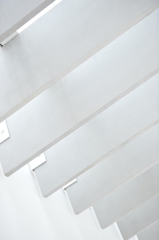 A close up of white boards across a white wall and ceiling