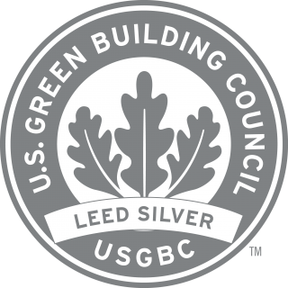 Round silver logo with 3 leaves with the text "U.S. Green Building Council USGBC LEED Silver"